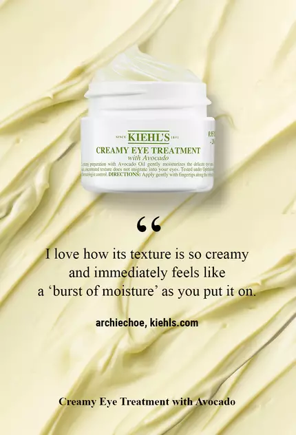 A jar of Kiehl's Creamy Eye Treatment with Avocado against a creamy, textured background, accompanied by a customer testimonial about its moisturizing texture.