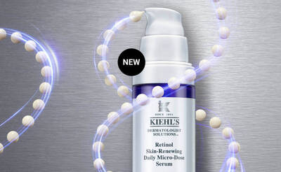 A bottle of Kiehl's Retinol Skin-Renewing Daily Micro-Dose Serum on a metallic background, surrounded by a stylized representation of molecules, with a "NEW" label prominently displayed.