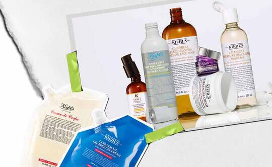 Een verzameling huidverzorgingsproducten van Kiehl's, waaronder lotions en serums, artistiek gerangschikt met levendige verpakkingen en labels zichtbaar.