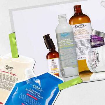 Een verzameling huidverzorgingsproducten van Kiehl's, waaronder lotions en serums, artistiek gerangschikt met levendige verpakkingen en labels zichtbaar.