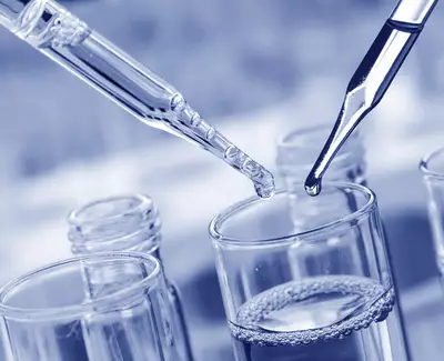 Close-up of two droppers above a glass container filled with a clear liquid, set against a blue-toned background.