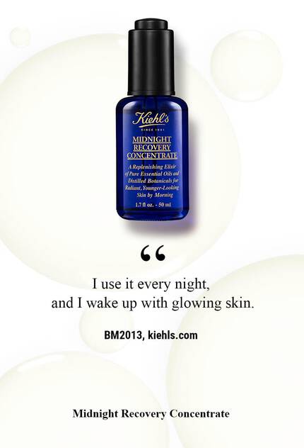 A dark blue bottle of Kiehl's Midnight Recovery Concentrate is displayed against a light background, accompanied by a quote about its nightly use for glowing skin.