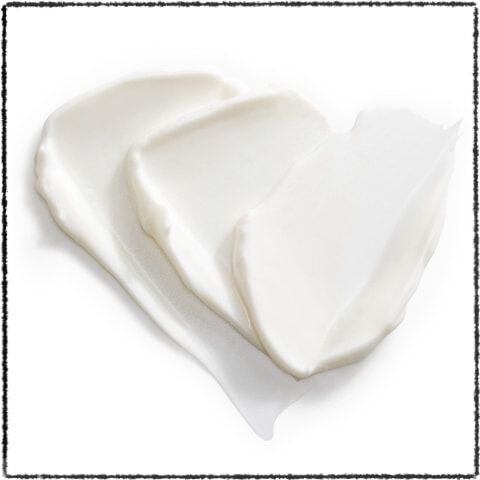 three smooth, white cream or lotion textures layered on top of each other.