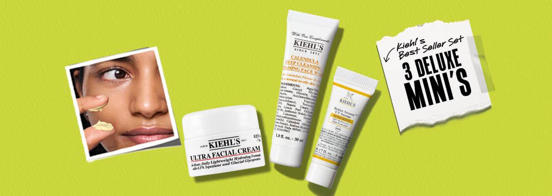 Een liggende promotionele banner van Kiehl's tegen een effen limoengroene achtergrond met een lichte textuur, waarop aan de linkerkant een vierkante Polaroid-foto te zien is van een persoon die een lichtgele creme onder het oog aanbrengt. In het midden van de banner liggen drie luxe productminiaturen op een rij, bestaande uit een heel kleine witte Ultra Facial Cream, een grotere witte tube Calendula Deep Cleansing Foaming Face Wash en een kleine witte tube met een geel vlak voor de Better Screen UV Serum Sunscreen SPF 50+. Aan de rechterkant bevindt zich een gescheurd wit papiertje, vastgeplakt met transparant plakband, met de handgeschreven tekst "Kiehl's Best Seller Set" en een pijltje dat wijst naar de grote, dikgedrukte zwarte tekst "3 DELUXE MINI'S".