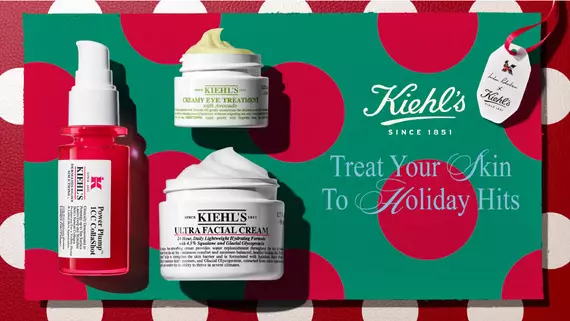 Promotionele afbeelding op een felgele achtergrond met twee Kiehl's-producten: het paarse ""Retinol Skin-Renewing Daily Micro-Dose Serum"" en het gele ""Better Screen UV Serum Sunscreen SPF 50"". De tekst luidt: ""Ontmoet je power duo voor dag & nacht. Vernieuw & bescherm.