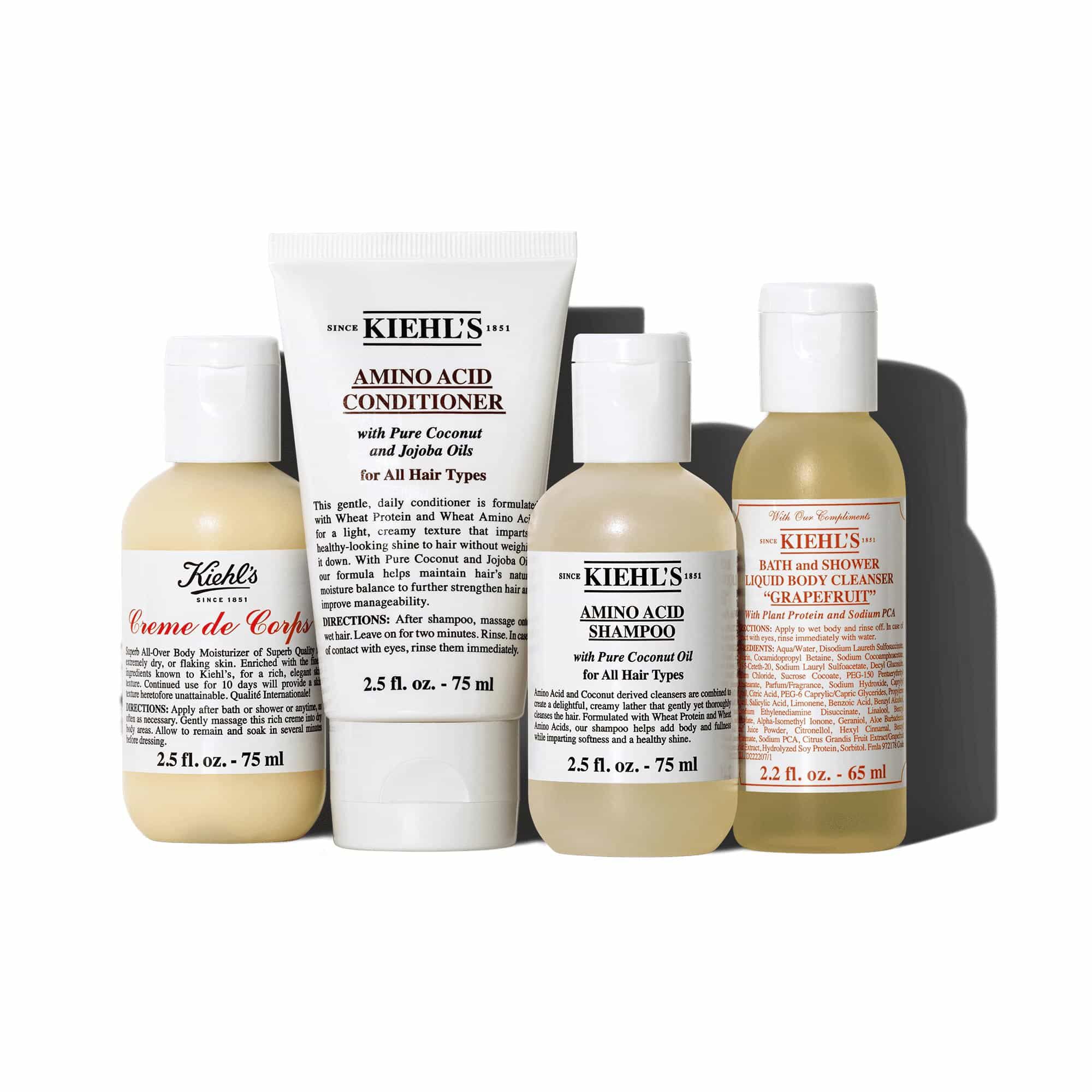Een afbeelding met vier producten tegen een witte achtergrond: een fles "KIEHL'S CREME DE CORPS", een tube "KIEHL'S AMINO ACID CONDITIONER", een fles "KIEHL'S AMINO ACID SHAMPOO" en een fles "KIEHL'S BATH AND SHOWER LIQUID BODY CLEANSER GRAPEFRUIT".