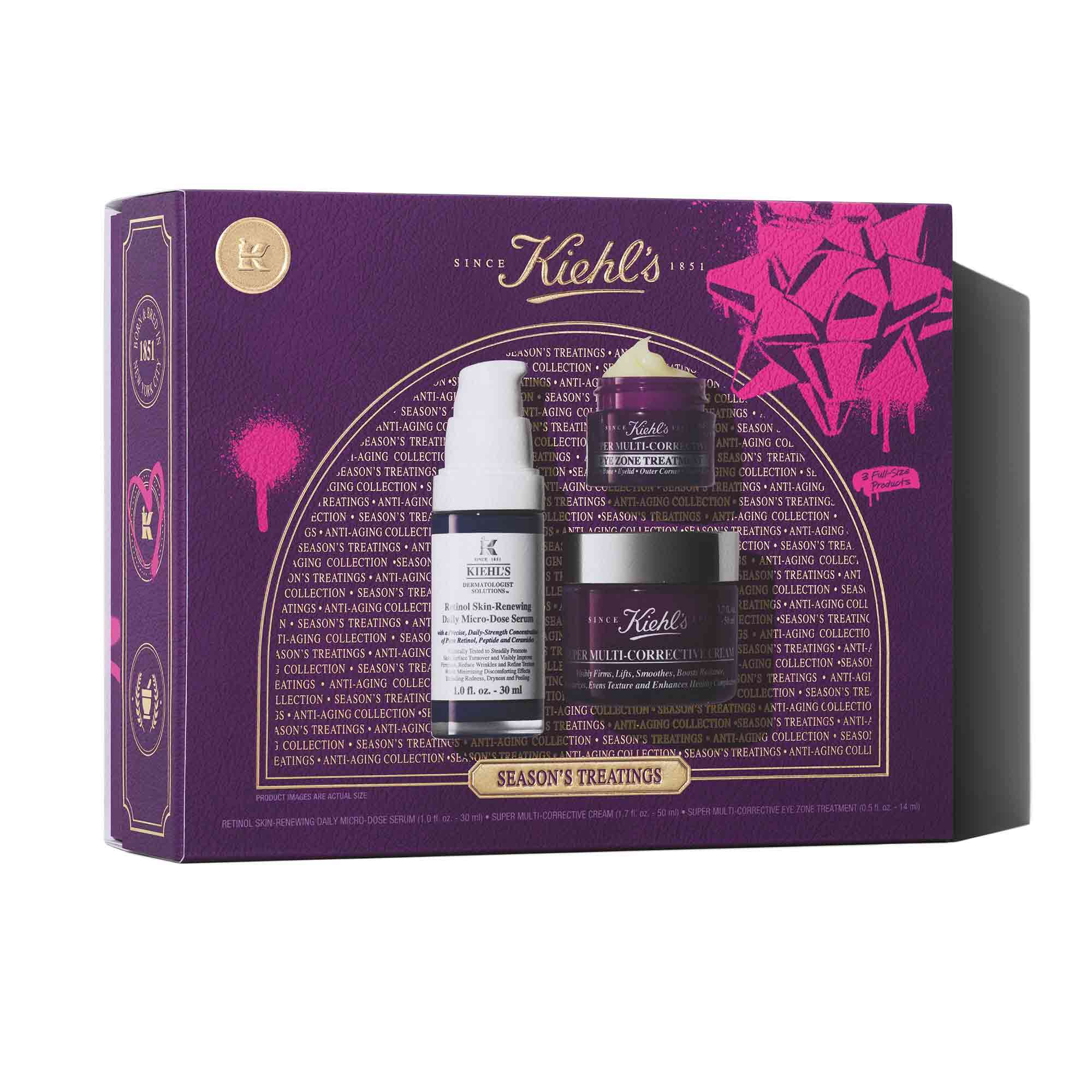 Een afbeelding van een rechthoekige paarse en roze geschenkverpakking van Kiehl's "SEASON'S TREATINGS ANTI-AGING COLLECTION", met daarin een witte en paarse flacon Retinol Skin-Renewing Daily Micro-Dose Serum, een kleine paarse flacon Super Multi-Corrective Eye Zone Treatment en een grotere paarse flacon Super Multi-Corrective Cream.