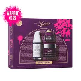 Een afbeelding met een rechthoekige paarse en roze geschenkverpakking van Kiehl's "SEASON'S TREATINGS ANTI-AGING COLLECTION". Voor de verpakking bevindt zich een witte en paarse flacon Retinol Skin-Renewing Daily Micro-Dose Serum, een kleine paarse flacon Super Multi-Corrective Eye Zone Treatment en een grotere paarse flacon Super Multi-Corrective Cream.